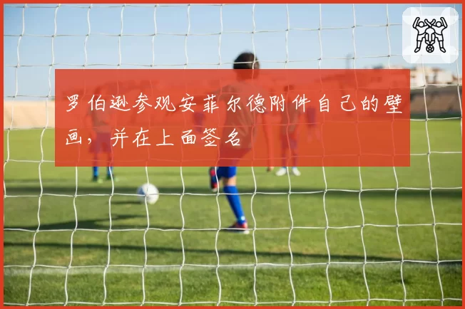罗伯逊参观安菲尔德附件自己的壁画,并在上面签名